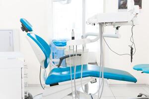 Dentist workspace with modern chair, equipment and instruments photo