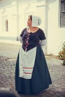 Portrait of brunette woman dressed in historical Baroque clothes with old fashion hairstyle photo