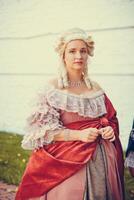Portrait of blonde woman dressed in historical Baroque clothes with old fashion hairstyle photo