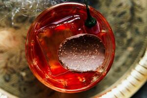 Alcoholic drink. A cocktail with elite alcohol on dark black background photo