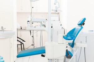 Dentist workspace with modern chair, equipment and instruments photo