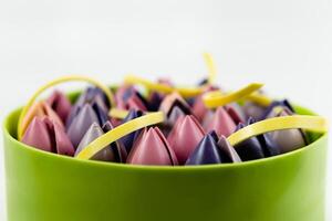 Close-up of mousse cake decorated with chocolate tulip, close up, white background. photo