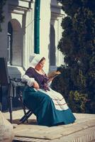 Portrait of brunette woman dressed in historical Baroque clothes with old fashion hairstyle photo