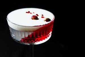 Alcoholic drink. A cocktail with elite alcohol on dark black background photo