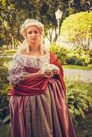 Portrait of blonde woman dressed in historical Baroque clothes with old fashion hairstyle photo