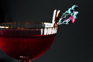 Alcoholic drink. A cocktail with elite alcohol on dark black background photo