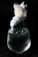 Alcoholic drink. A cocktail with elite alcohol on dark black background photo