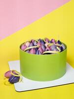 Close-up of mousse cake decorated with chocolate tulip, close up, yellow and pink background photo