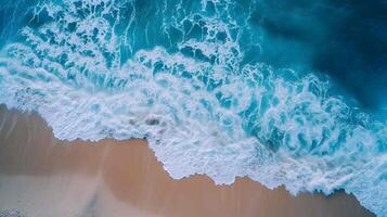 Amazing aerial view of emerald green sea, small white sand beach with perfect nature and white foamy waves crashing on the shore on a sunny day. photo