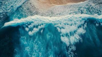 Amazing aerial view of emerald green sea, small white sand beach with perfect nature and white foamy waves crashing on the shore on a sunny day. photo