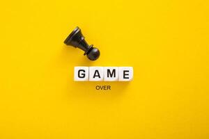 Game Over word and concept. Block letters on bright yellow background photo