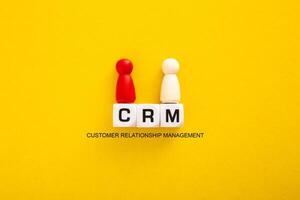 Customer Relationship Management CRM on Yellow Background. photo