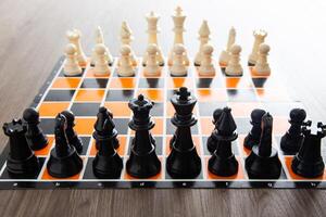 Chess board game on wooden table photo