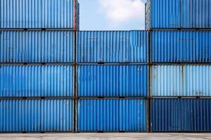 blue shipping containers stacked up against each other photo