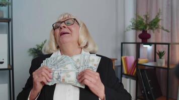 Business woman accountant celebrating business success dancing with stack of money dollar cash video