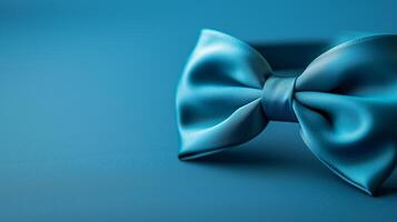 Elegant blue satin bow tie. Close-up of an elegant blue satin bow tie with a smooth texture, displayed on a matching blue background, symbolizing classic style and sophistication. photo