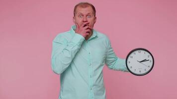 Confused man with anxiety checking time on clock, running late to work, being in delay, deadline video