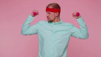 Young adult man making fitness exercises with dumbbells alone, working out pumping up arm muscles video