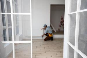 A man changes the heating in the house, radiators. The concept of modern heating, replacement of the old with a new one. Warmth in the house photo