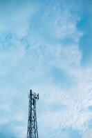 tower, bts, gadget operator signal transmitter tower with clouds and clear, blue sky photo