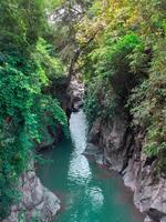 waterfall with turquoise water and rock cliffs photo