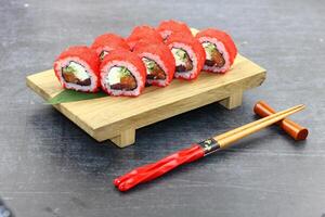 Sushi delivery. Set of rolls in a disposable box on a black background. Top view photo