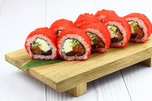 Sushi delivery. Set of rolls in a disposable box on a black background. Top view photo