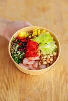 Hawaiian shrimp poke bowl with seaweed, avocado, mango, radish, sesame seeds. Top view, overhead, flat lay, copy space photo