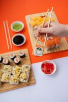 Sushi delivery. Set of rolls in a disposable box on a black background. Top view photo