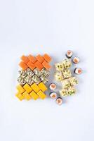 Sushi delivery. Set of rolls in a disposable box on a black background. Top view photo