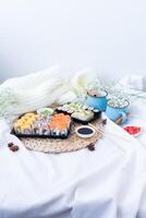 Sushi delivery. Set of rolls in a disposable box on a black background. Top view photo