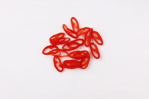 sliced red hot chili peppers isolated on white background top view photo