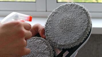 Close-up Glass cleaner and mirror are applied to a sponge from a window cleaning robot video