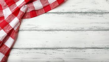 Old white vintage wooden table with red checkered tablecloth. photo