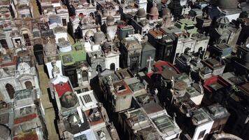 Top-down aerial view of Buenos Aires cemetery. Urban necropolis, historic chapel amidst ancient graves. Broken, obsolete, vintage tombstones, metal stacks. City s historic environment captured by video