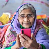 Indian old lady taking a mobile selfie photo