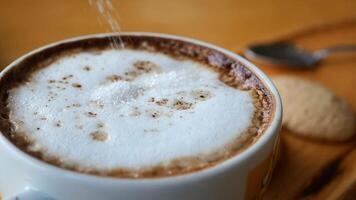 slow motion of dropping sugar cube in a coffee cup , video