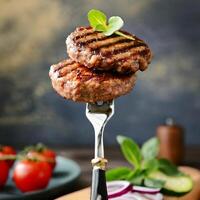 grilled beef patties on a fork photo