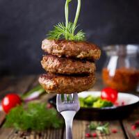 grilled beef patties on a fork photo