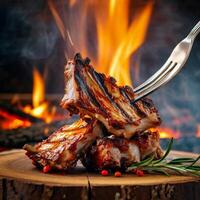 grilled beef ribs on the grill chopped on a fork against a fire photo