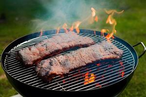 Spare ribs grilling on barbecue for a summer party photo