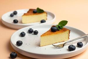 Cheesecake Slice On Plate With Blueberries, Pink Background. Trendy Fashion Dessert photo