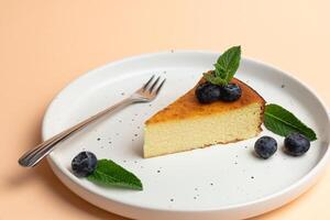 Cheesecake Slice On Plate With Blueberries, Pink Background. Trendy Fashion Dessert photo