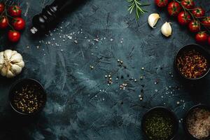 Dark stone kitchen background with spices, herbs and kitchen utensils. Free space for text. Top view. Rustic style. photo