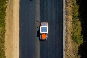 Asphalt repairing machine, aerial shot of working constructive machinery. photo