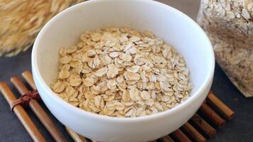 milk pouring in a bowl of roasted oats flakes video