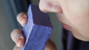 Young Woman Smelling a Bar of Natural Homemade Soap. video