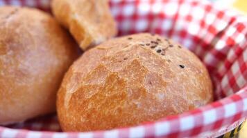 bread rolls rest in a black bowl on the table video