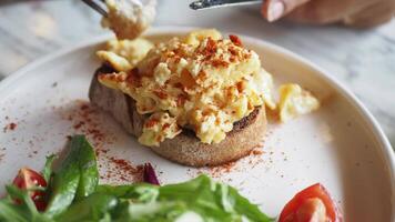 morning breakfast with Scrambled eggs on a bread on white plate video