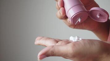 Close up of woman pouring moisturizing cream on hand f video